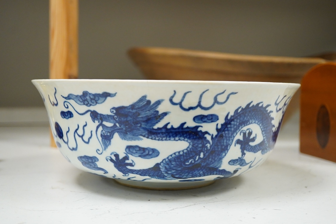 A Chinese blue and white dragon bowl, Kangxi mark but later, 26cm diameter